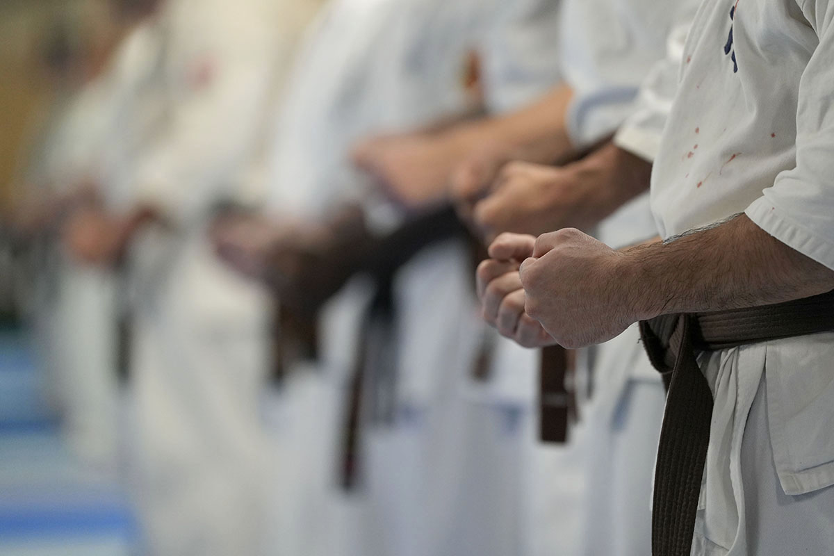 Kyokushin karateka standing together during dojo training