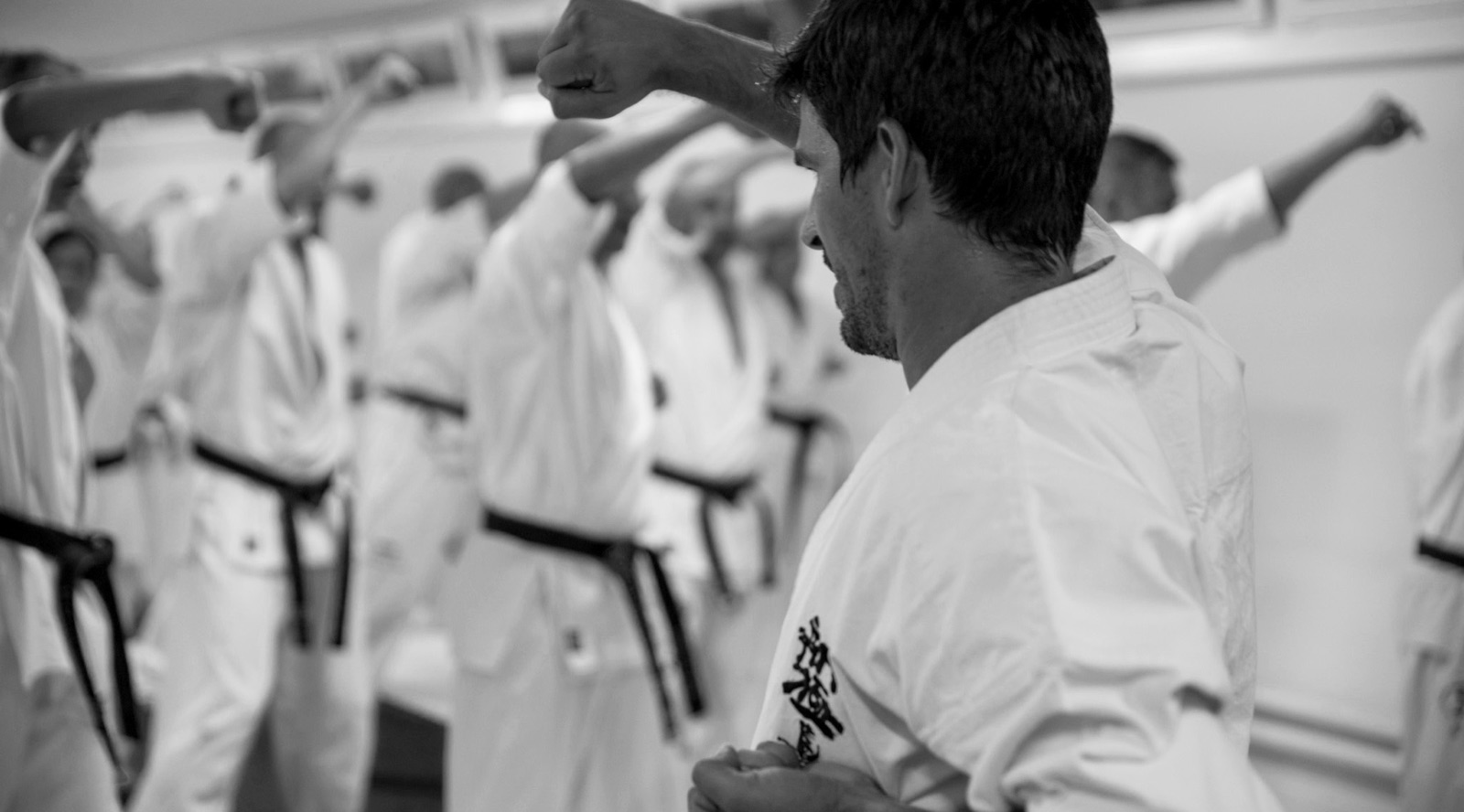 Kyokushin karateka training kihon together in the dojo
