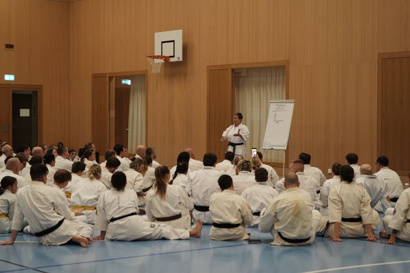 Participants sitting on the floor during an explanation