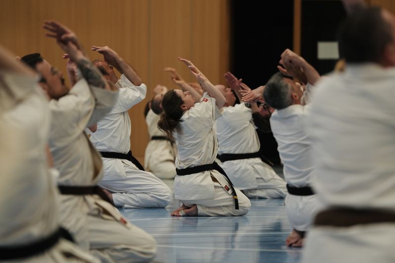Participants kneeling during a kata movement